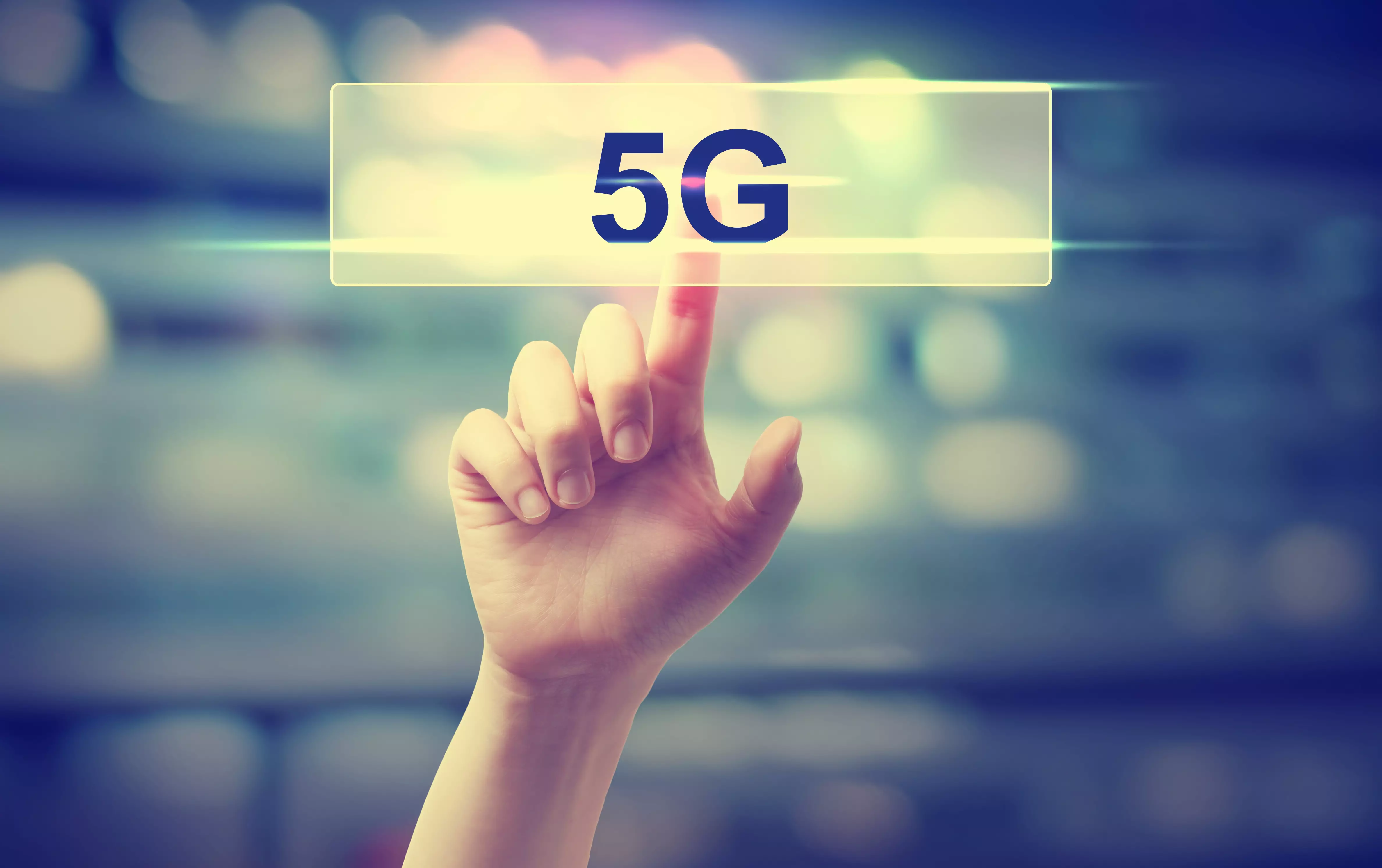 5G concept with hand pressing a button on blurred abstract background