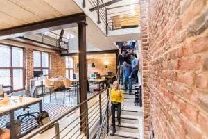 Découvrez des bureaux du futur : ces innovations surprenantes vont radicalement changer votre quotidien au travail Photo of Woman in Yellow Top Walking Down Stairs in a Office Room