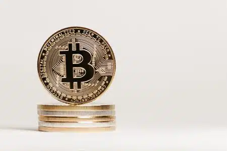 Golden Bitcoin displayed prominently on a white background showcasing cryptocurrency value.